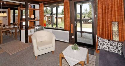 Wooden Chalet with Terrace near Swimming Lake