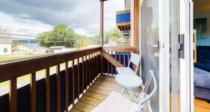 Inviting condo in quiet locale with partial lake views, balcony & grilling area