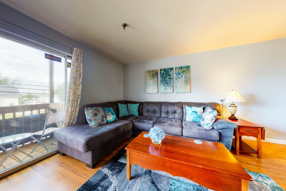 Inviting condo in quiet locale with partial lake views, balcony & grilling area
