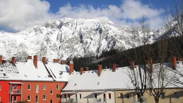 Zona residencial con edificios cubiertos de nieve y una montaña al fondo.