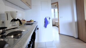 A modern kitchen with white cabinets, a coffee maker, and a sink. - Expansive Holiday Home in Mecklenburg near Baltic Sea (Walkendorf)