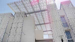A building with a geometric facade and a large, open interior space. - Maisonette in France With Terrace (Agde)