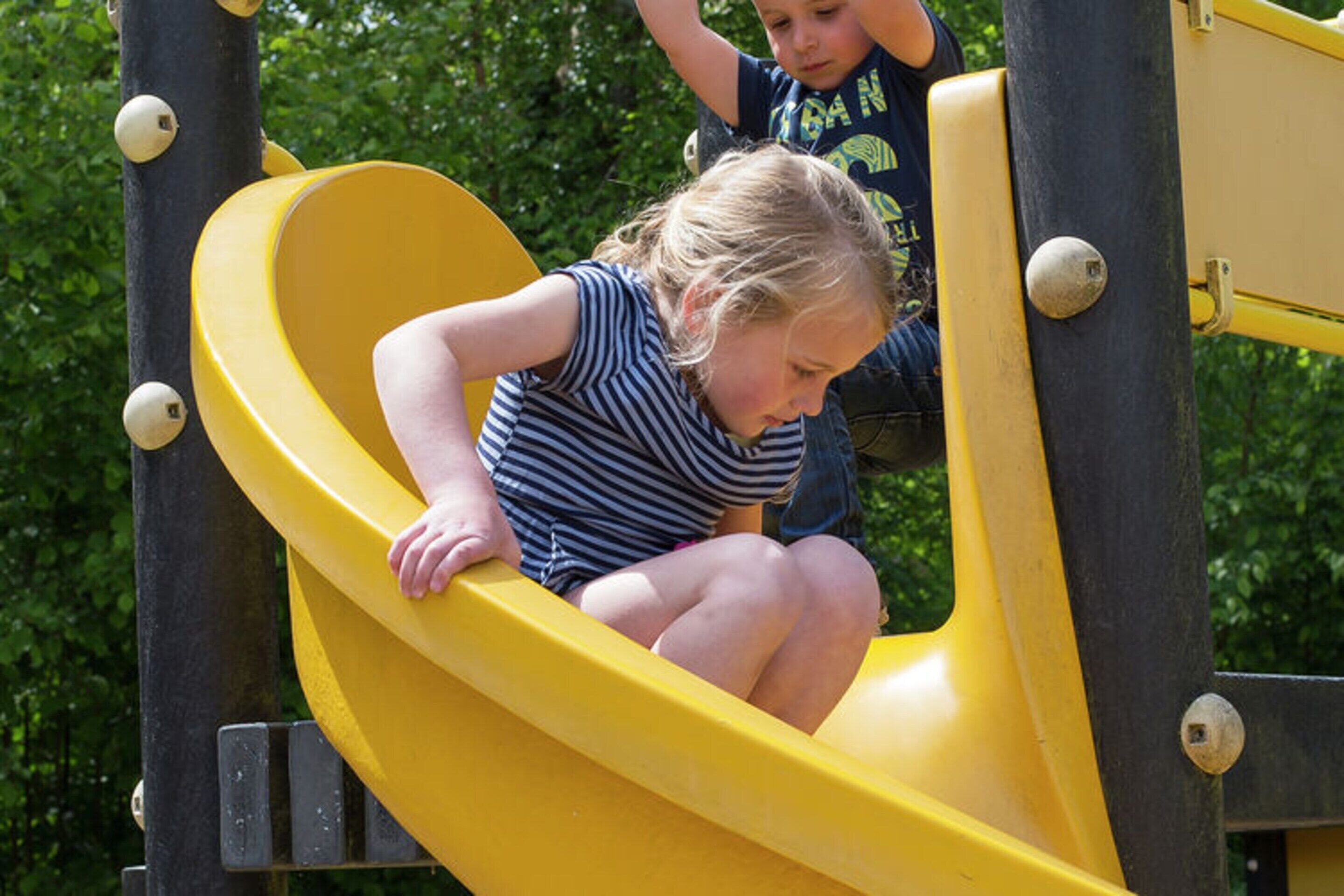 A playground with a yellow slide.