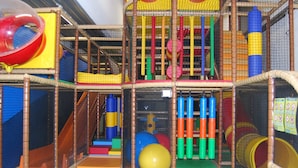 An indoor play area with various play structures, including a slide, climbing nets, and soft play surfaces. - Cozy Lodge in the Achterhoek (Winterswijk - Brinkheurne)