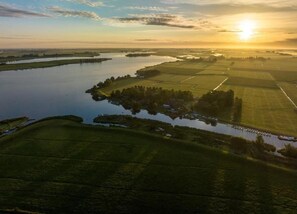 An aerial view of a river with surrounding fields and a small settlement. - Modern Chalet Near Lake Sneek (Terkaple)
