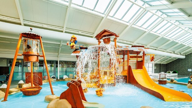 An indoor water park with slides, water play areas, and a large pool. - Chalet With Terrace at the Lake and Beach (Maurik)