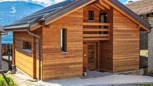 A wooden cabin with a sloped roof, a chimney, and a small porch. - Stunning private villa for 4 people with WIFI, TV and terrace (Savièse)