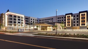 A modern hotel with a prominent entrance, multiple floors, and a well-lit facade. - Hampton Inn by Hilton Irvine Spectrum/Lake Forest (Lake Forest)