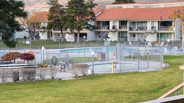 A hotel with a swimming pool, outdoor seating, and a view of mountains. - Newly Renovated! CB Condo unit 104 (sleeps up to 8) (Quincy)