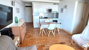 A compact living space with a kitchenette, a dining area, and a seating area. - MAGNIFIQUE APPARTEMENT AVEC VUE IMPRENABLE SUR LA MER (LE CAP D AGDE)