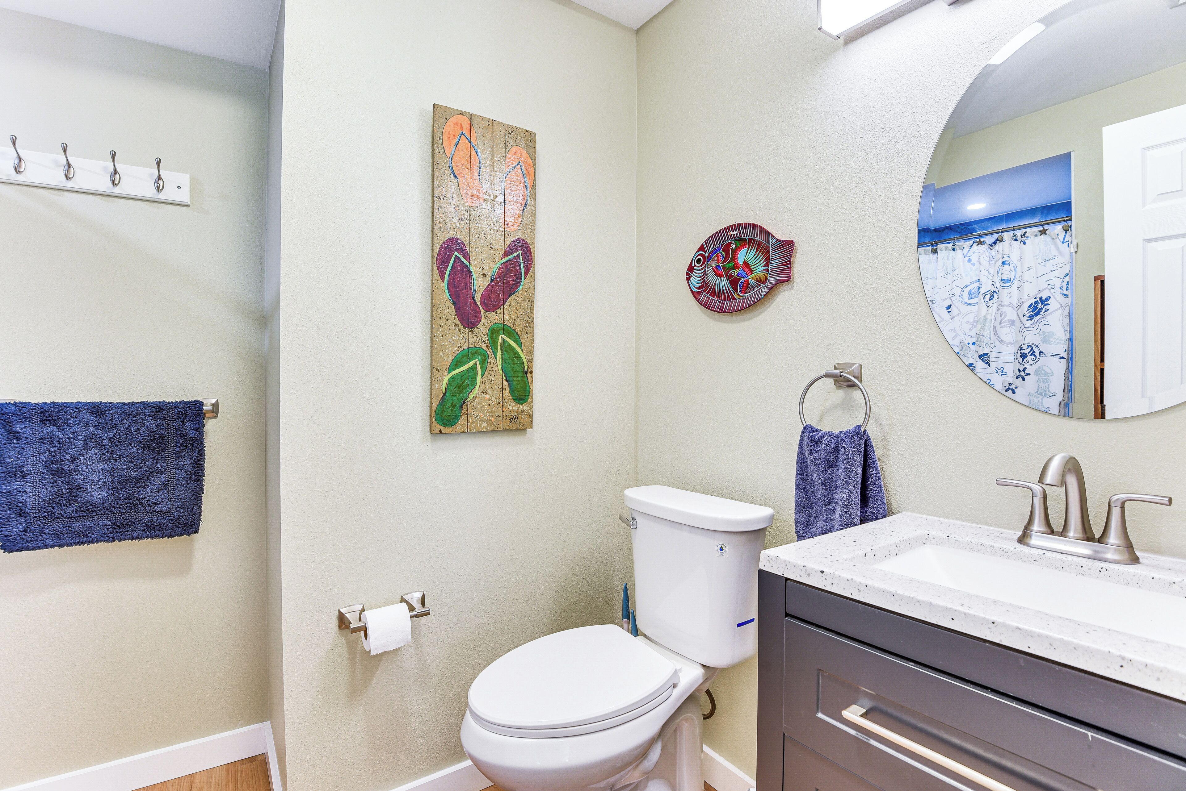 A bathroom with a toilet, sink, and towel rack.
