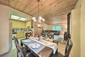 Enjoy meals in this inviting dining area with a long table and cozy seating area.