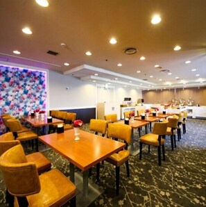 Enjoy meals in the dining area with a wooden table and chairs.