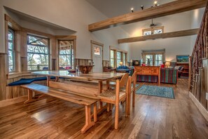 A spacious kitchen with wooden countertops, a large island, and ample natural light from windows. - The Poplars at Bearwallow Mountain | Two Mountain Homes with Event Pavilion near Asheville (Hendersonville)