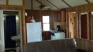 A compact cabin with a kitchenette, a bathroom, and a living area. - Rustic Lakefront Cabin near Saugatuck&South Haven (Fennville)