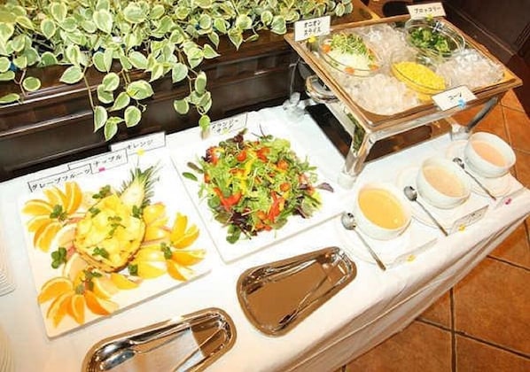 Enjoy a sumptuous spread of international cuisine at our buffet, featuring a variety of dishes and condiments.