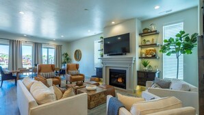 A spacious living room with a fireplace, comfortable seating, and a large flat-screen TV. - Poolside | Near Pickleball Courts | Shuffleboard | Arcadia #14 (Santa Clara)