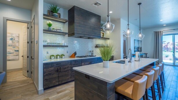 A modern kitchen with a large island, dark wood cabinets, and pendant lighting. - Poolside | Near Pickleball Courts | Shuffleboard | Arcadia #14 (Santa Clara)