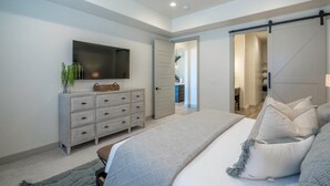 A bedroom with a bed, a TV, a dresser, and a sliding door closet. - Poolside | Near Pickleball Courts | Shuffleboard | Arcadia #14 (Santa Clara)