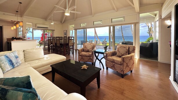 A spacious living area with a high ceiling, a ceiling fan, and a view of the ocean. - Sacred South Maui Beach House Sweeping Ocean Views Hot Tub Turtle Shore (Kihei)