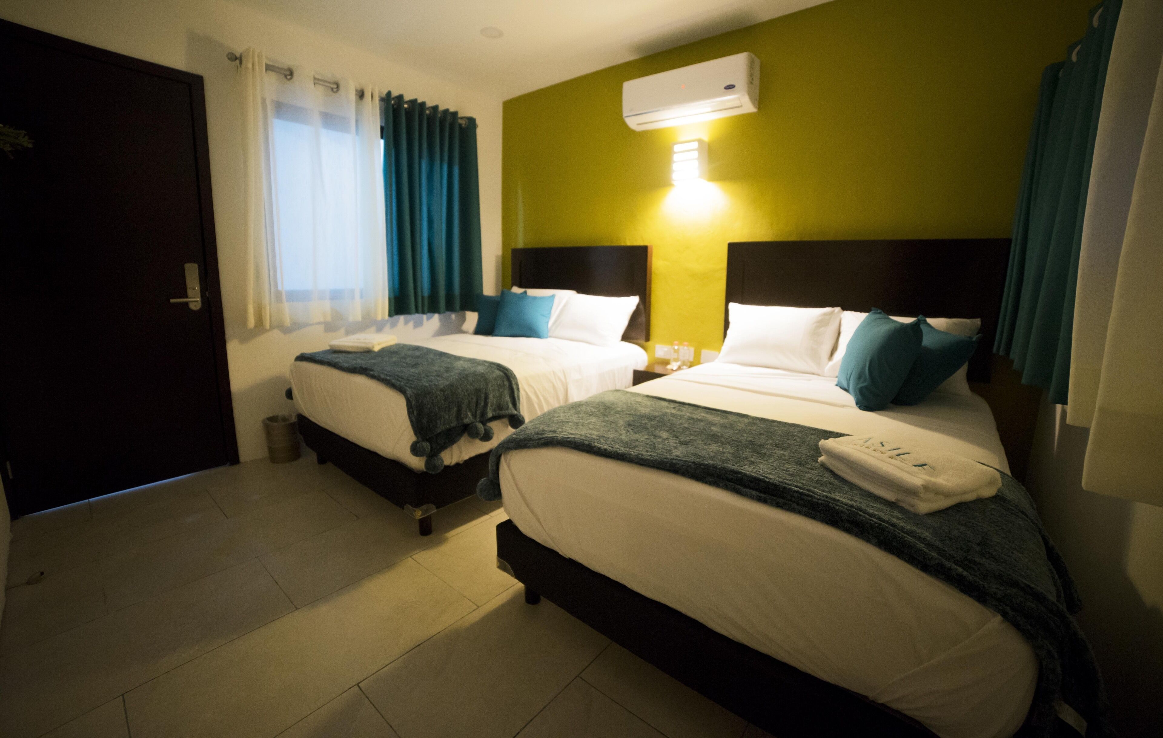 basic room, 2 double beds | 1 bedroom, down duvets, blackout curtains, iron/ironing board