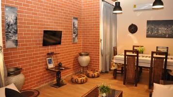 Family Apartment, 2 Bedrooms | Living area | TV, toys