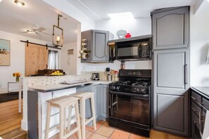 Fridge, microwave, coffee/tea maker, cookware/dishes/utensils