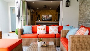 A modern living room with a sofa set, a coffee table, and a television. - Belmont Shore BH - Unit A  (Long Beach)