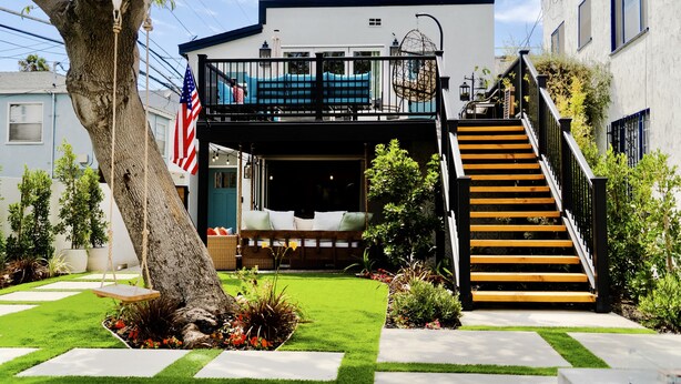 A modern two-story house with a balcony, a staircase, and a well-maintained garden. - Belmont Shore BH - Unit A  (Long Beach)