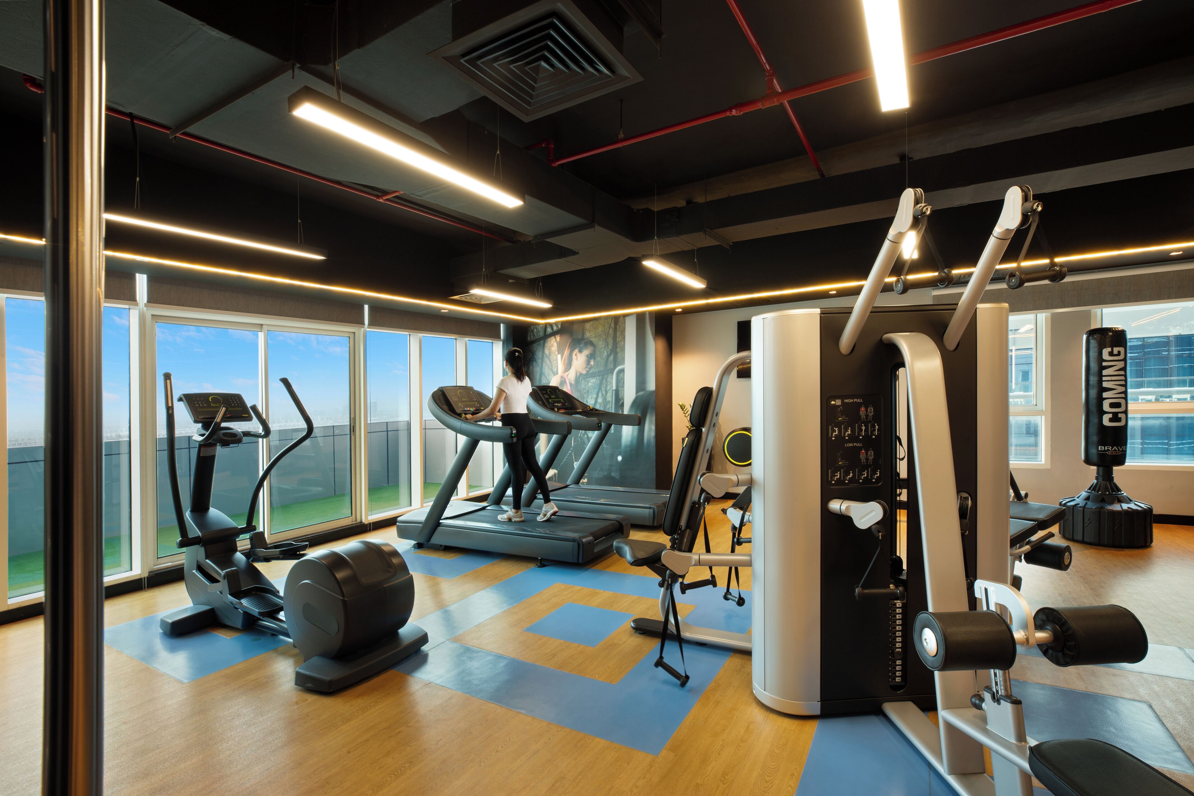 A gym with treadmills, elliptical machines, and weight equipment.