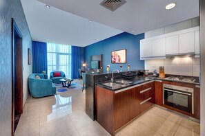Deluxe Apartment, 1 Bedroom (Burj Khalifa View) | Private kitchen | Full-size fridge, microwave, espresso maker, coffee/tea maker - Royal Continental Suites (Dubai)