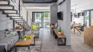A modern living space with a staircase, a dining area, and a kitchen. - Beach front home in Medulin (Medulin)