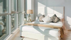 A modern bedroom with a large bed, a bedside table with a lamp, and a view through a glass door. - Elite Royal Apartment - Burj Khalifa & Fountain view - Senator (Dubai)