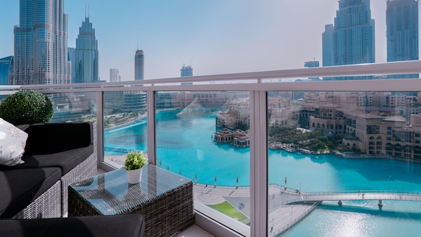 A balcony with a view of a city skyline and a turquoise body of water. - Elite Royal Apartment | Burj Khalifa & Fountain view | Star (Dubai)
