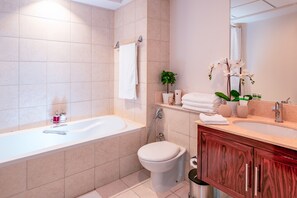A modern bathroom with a bathtub, toilet, and vanity. - Elite Royal Apartment - Burj Khalifa & Fountain view - Caesar (Dubai)