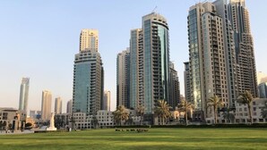 A cityscape with high-rise buildings, including a prominent tower with "EMAAR" signage.