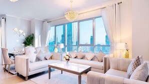 A modern living room with a sofa set, a coffee table, and a chandelier. - Elite Royal Apartment - Burj Khalifa & Fountain view - Royal (Dubai)