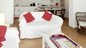 A compact hotel room with a bed, a small table, and a kitchenette in the background. - Beautiful  villa for 9 people with WIFI, A/C, TV, terrace and pets allowed (Sanremo)