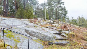 A rocky outdoor area with metal railings and steps, surrounded by trees. - 3 bedroom lovely home in Strömstad (Strömstad)
