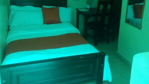 A room with a bed, a desk, and a chair. - Longonot Inn (Mai Mahiu)