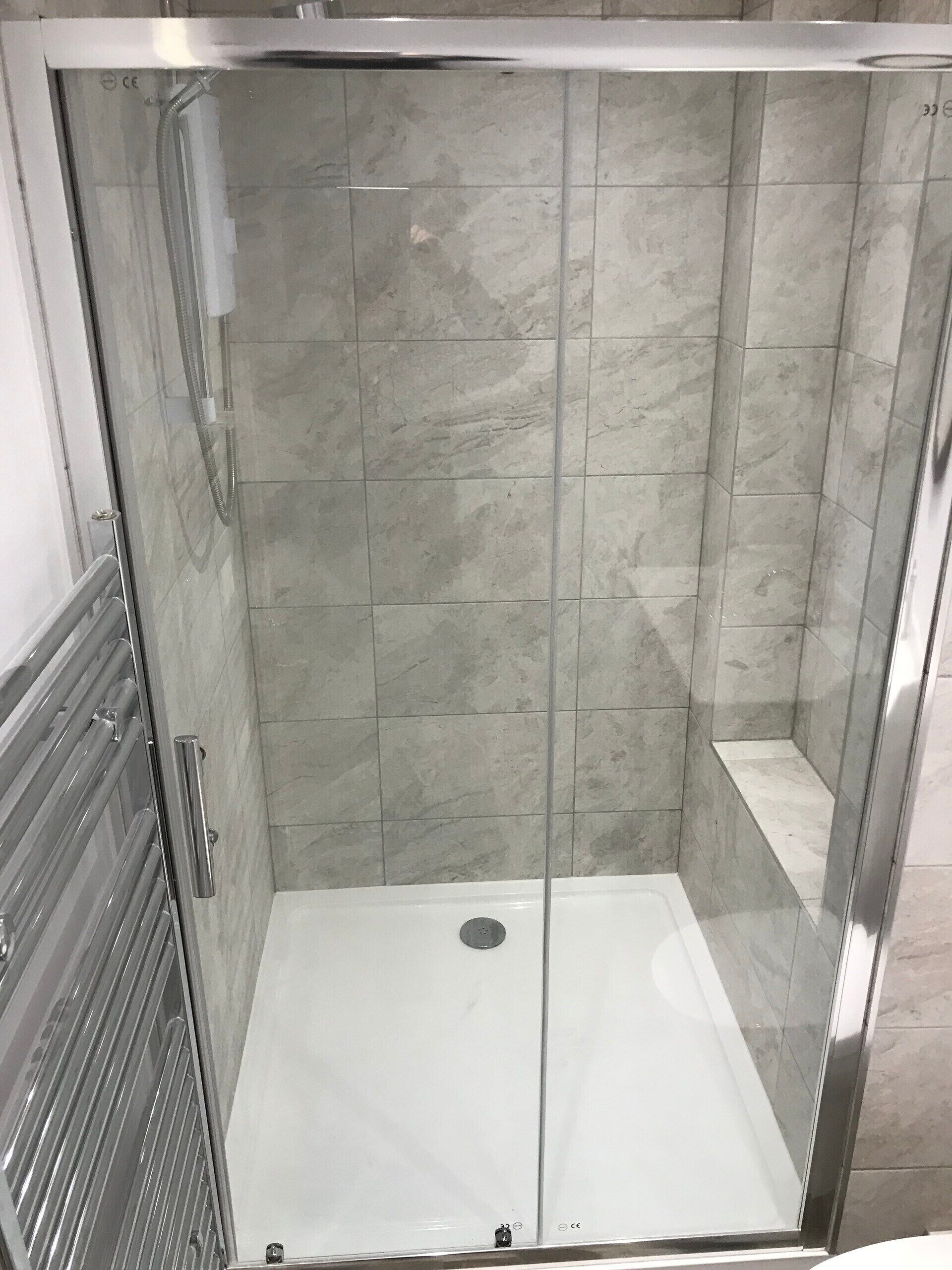 Shower, hair dryer, towels, shampoo
