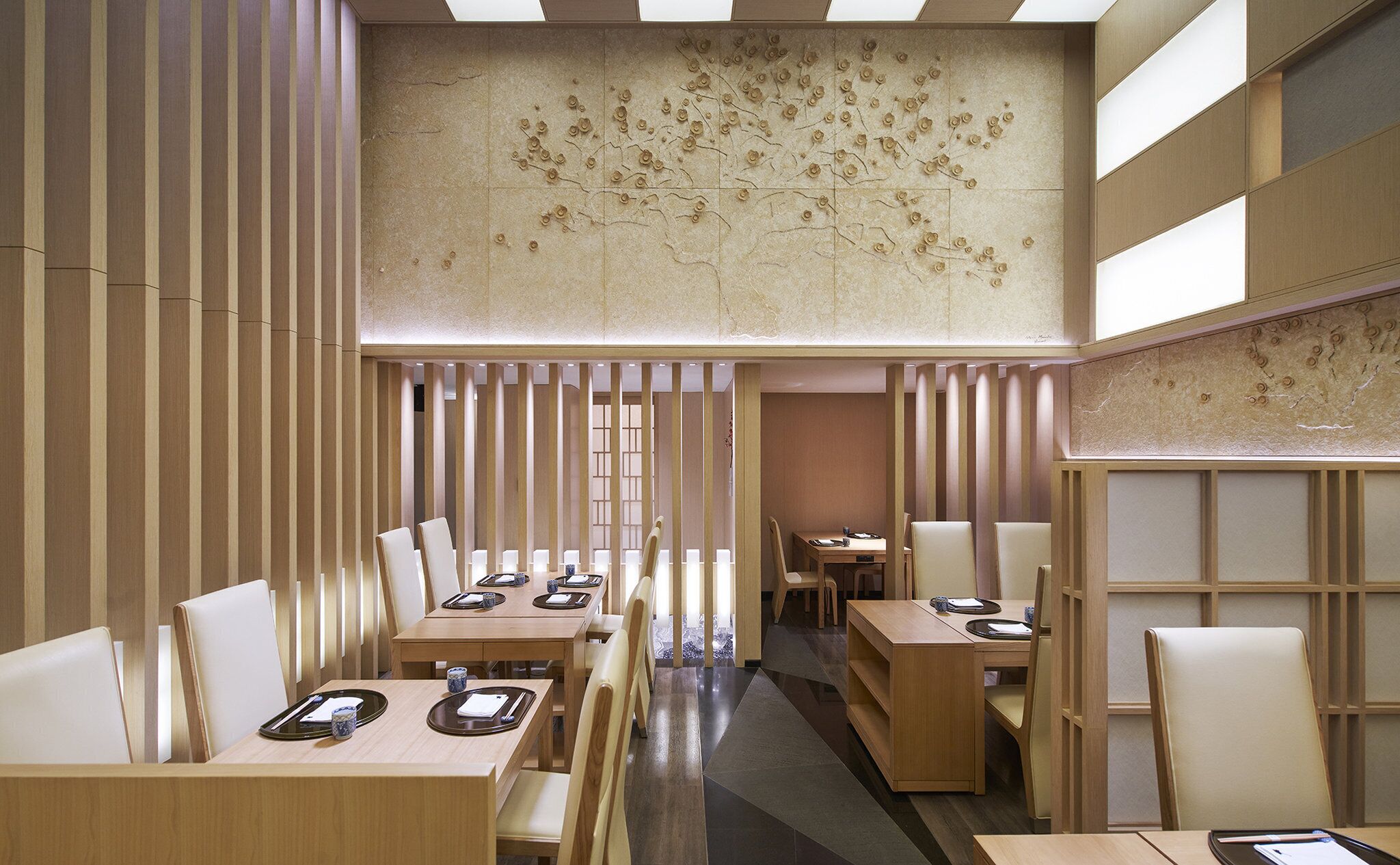 A modern interior with wooden paneling, a high ceiling, and a central walkway.