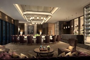 A modern hotel lobby with a bar, seating area, and a large chandelier. - Hengxu International Hotel (Yibin)