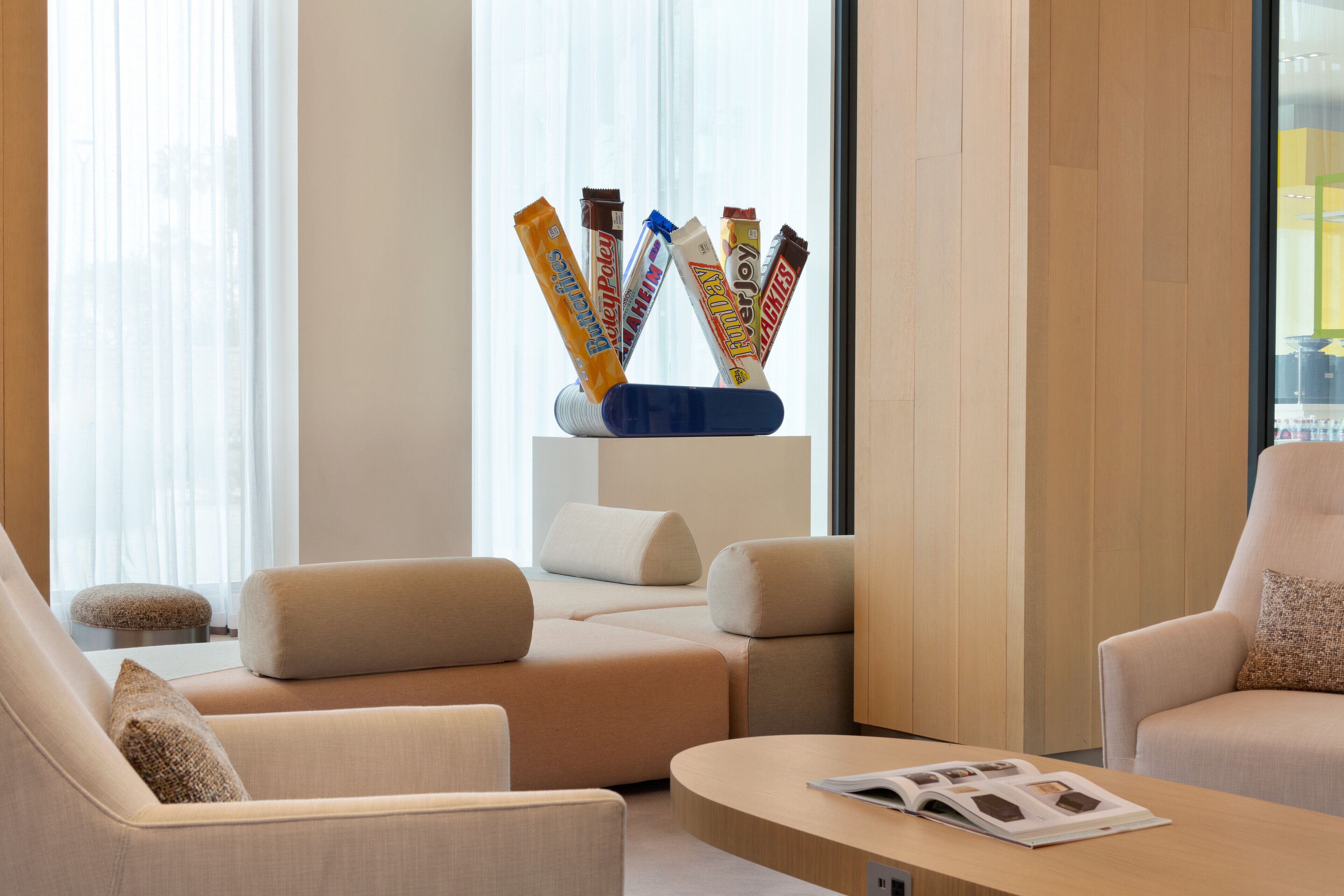 A modern living room with a sofa, a coffee table, and a magazine.