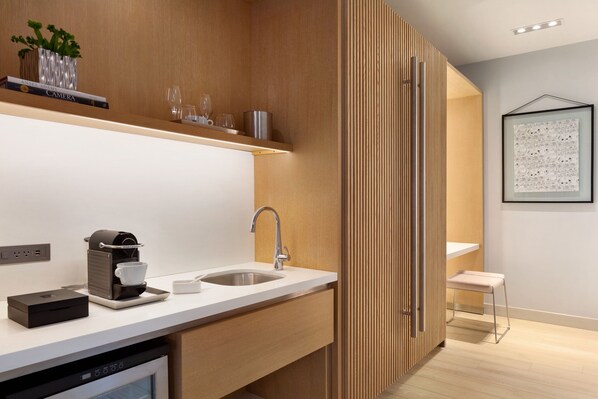 Una cocina moderna con lavavajillas, cafetera y pileta.