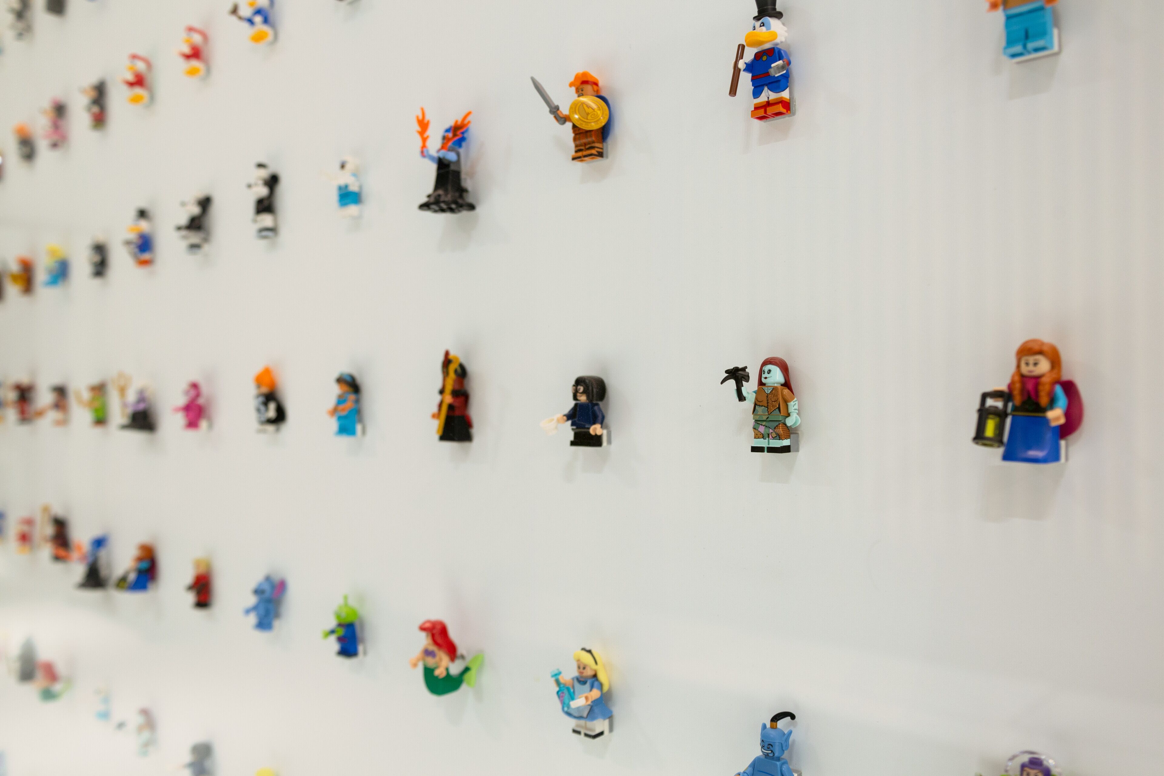 A wall with various LEGO figures displayed in a grid pattern.