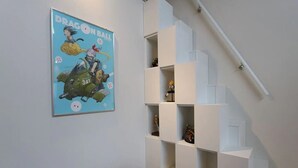 A staircase with white railings and shelves on the wall. - Shibuya Stay Tokyo (Tokyo)