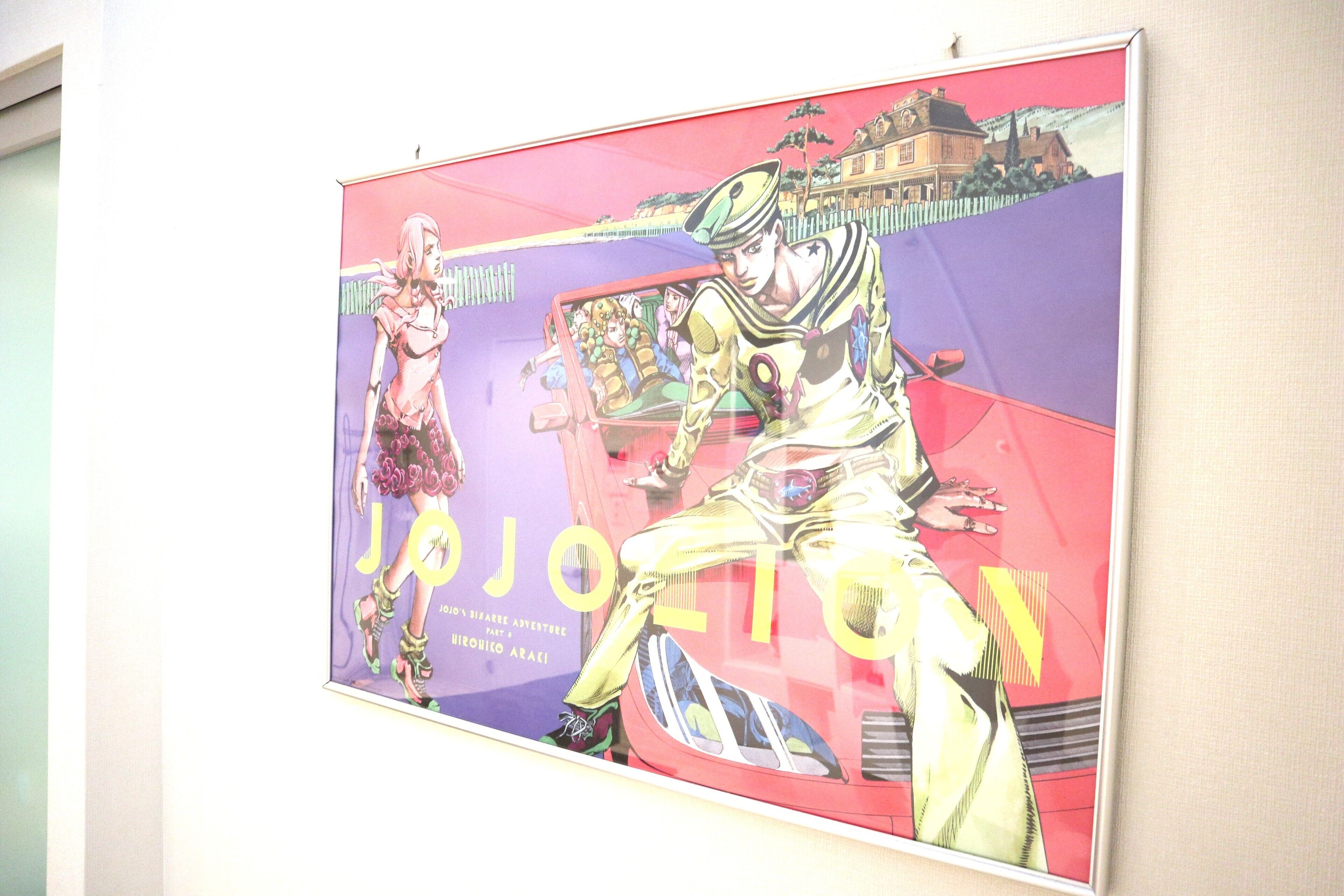 A poster with two characters, one in a military uniform and the other in a pink outfit, with the word "JOJO" visible.