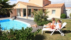 A house with a swimming pool, a covered patio, and a lawn. - Villa in France With Private Pool & Garden (Les Sables-d'Olonne)