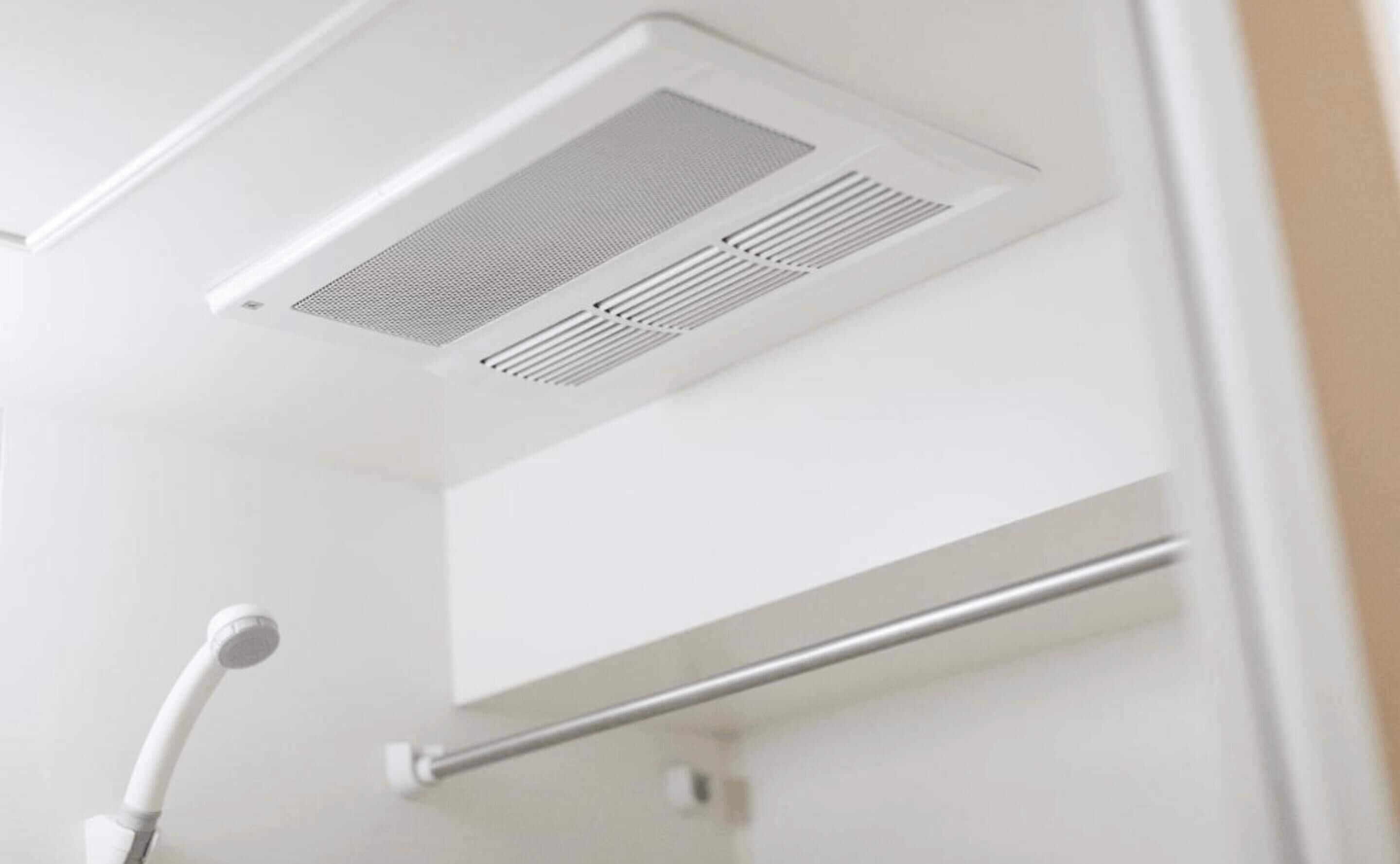 A bathroom with a shower, a towel rack, and a ceiling vent.